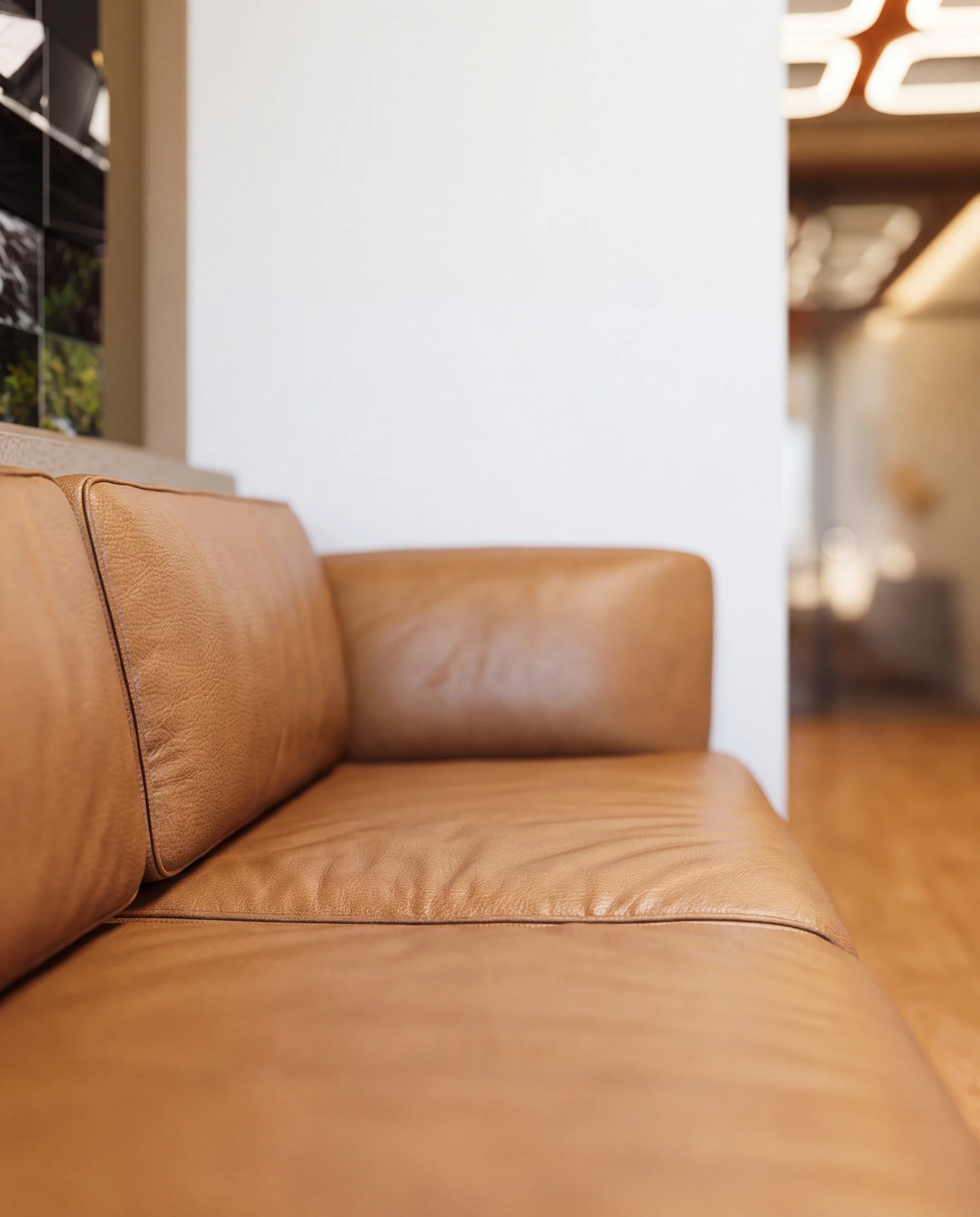 Arm of the tan leather reception sofa